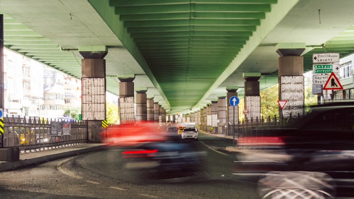 Dynamic view of an Istanbul underpass with blurred traffic, showcasing urban movement.